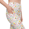Closeup of white high waisted leggings featuring spring floral print with bees and butterflies. Compression leggings with side pocket for women.