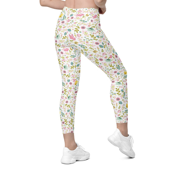 Back view of spring floral compression leggings for women. White high waisted leggings with pockets and soft pastel flower pattern.