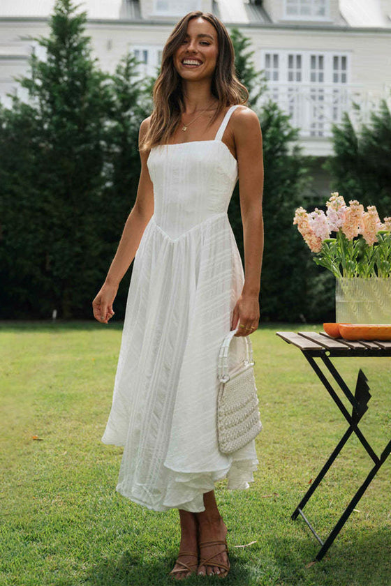 Woman wearing the Square Neck Wide Strap Cami Dress, styled with sandals and a woven bag for a casual summer look.