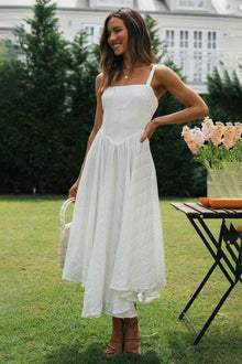  Woman wearing a Square Neck Wide Strap Cami Dress with a flowy ruffled hem, perfect for summer garden parties or casual outings.

