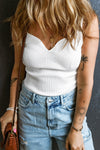 Woman wearing a white Sweetheart Neck Wide Strap Tank styled with high-waisted jeans, showcasing the ribbed texture and flattering neckline.

