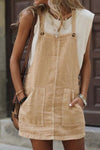 A stylish tan overall mini dress featuring a structured square neckline and chic side button details, perfect for a modern, effortless look.