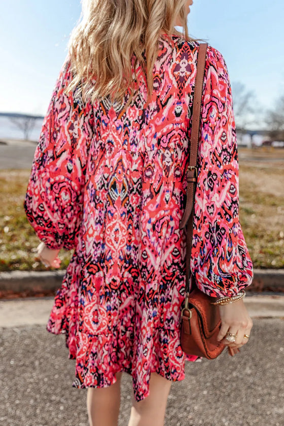 Back view of the Tassel Tie Neck Long Sleeve Dress, displaying the mini length and flowy silhouette.