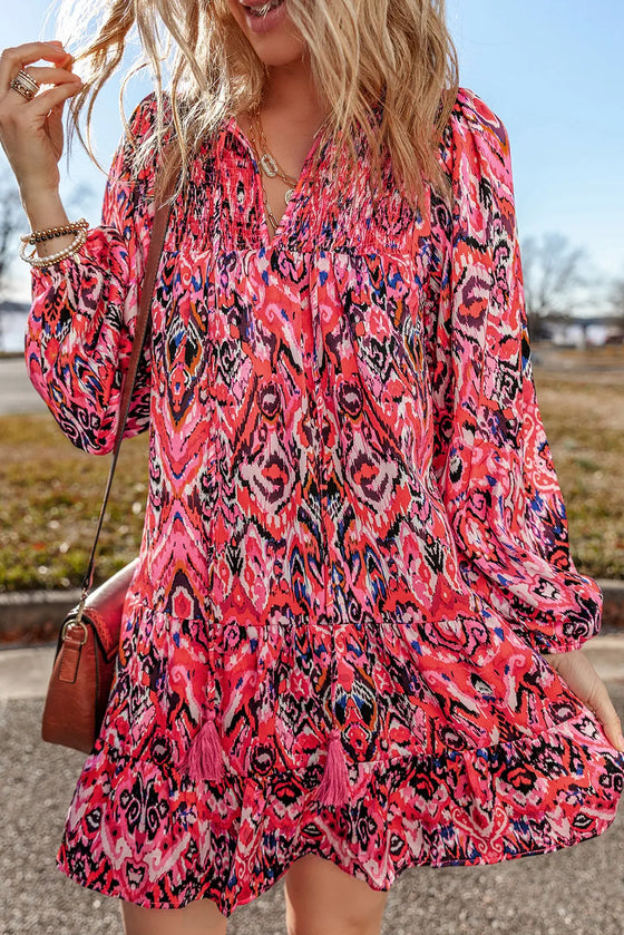 A model wearing the Tassel Tie Neck Long Sleeve Dress, styled with accessories for a chic, casual look