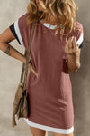 Woman wearing a textured short sleeve dress with a round neckline in light blue, styled with a crossbody bag for a casual look.