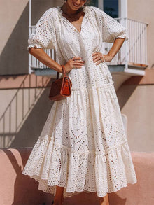  Woman wearing a Tie Neck Half Sleeve Tiered Dress with a flowy skirt, perfect for casual outings and special occasions.

