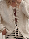 Close-up of the tie closures and dropped-shoulder design of the cardigan