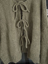 Front view of the Tied Long Sleeve Dropped Shoulder Cardigan in neutral beige, styled with casual striped pants.