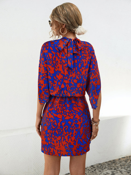 Back view of the Tied Printed Mock Neck Mini Dress showcasing its vibrant print and mini length.