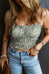 Close-up of a model wearing a green floral Tied Smocked Printed Square Neck Cami with adjustable tied straps and a flattering smocked bodice.

