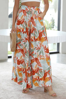  Woman wearing wide-leg pants with a tie-waist detail and pockets, perfect for a relaxed, casual look.