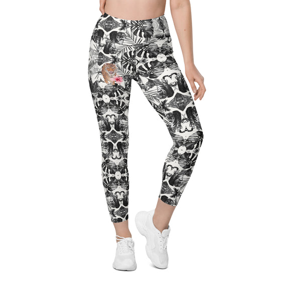 Woman wearing tiger print compression leggings with high waist and tapered legs. Ideal gym leggings with pockets for women’s fitness or casual wear.