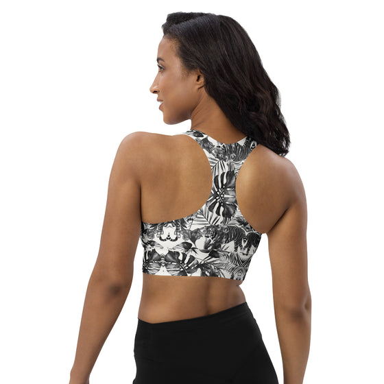 Model showing the back of a high support tiger print racerback sports bra. Seamless design with wide straps for gym and high impact workouts.