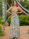 Woman wearing a Twisted Printed V-Neck Cami Dress featuring a bold floral print in orange and purple, with a maxi length and flattering silhouette.

