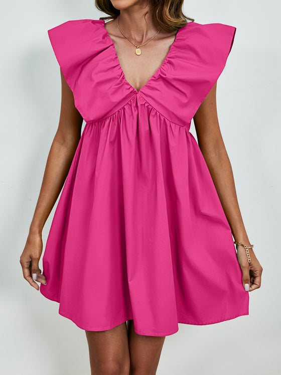 Woman wearing an orange V-Neck Cap Sleeve Mini Dress with a flowy A-line silhouette and charming cap sleeves, perfect for casual and dressy events.

