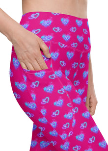  Closeup of Vibrant Neon Heart violet-red high-waisted leggings with pockets, showcasing sleek pocket design and bold neon heart print. Perfect for gym, yoga, or casual wear. High-rise compression leggings for women with functional pockets.