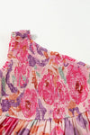 Detailed image capturing the shoulder seam and neckline design with rich texture and subtle floral accents on the pink fabric.

