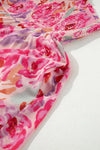 Closeup of the dress fabric with emphasis on the smooth texture and the clarity of the bold floral print on the flowy material.

