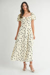 Front-facing view of vintage-style cream puff sleeve midi dress with delicate dot pattern and a tailored waistline.

