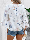 Back perspective of a fashionable white half sleeve blouse with graceful floral motifs and soft drape.