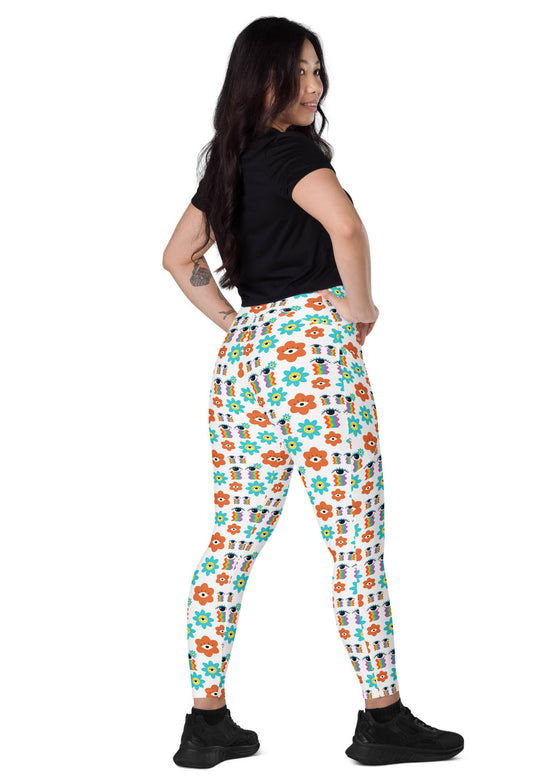 Model sitting with back view of white floral high waisted leggings, emphasizing the smooth fit, secure waistband, and functional side pockets.