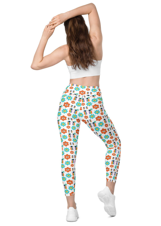 Model showing the back of white floral high waisted leggings with secure waistband and functional side pockets, offering comfort and support during workouts.