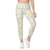 Full front pose of woman wearing white high waist leggings with spring floral design. Compression leggings with pockets for workouts and daily wear.
