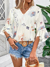A go-to white printed blouse with half sleeves, shown from the front on a model styled for comfortable everyday wear.