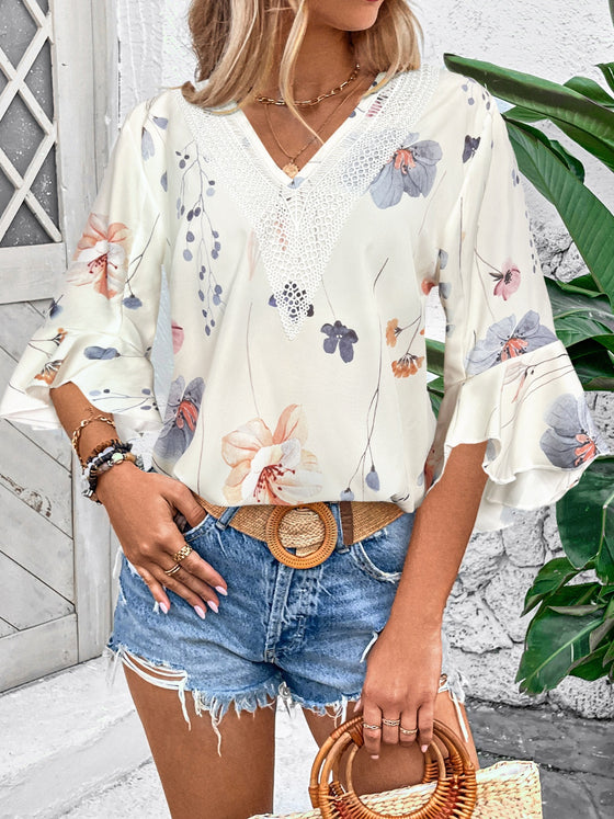 A go-to white printed blouse with half sleeves, shown from the front on a model styled for comfortable everyday wear.