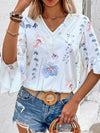 A stylish and versatile white blouse with delicate prints and short sleeves, modeled from the front for an effortless vibe.
