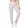Model standing in full front pose wearing white heart print leggings. Women's high waist leggings with side pockets and compression fit.
