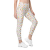 Model wearing high waisted white leggings with floral, bee, and butterfly print. Compression leggings for women with pockets, perfect for gym or yoga.