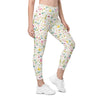 Model front view wearing white leggings with pastel floral print. High waist leggings with pockets, ideal for yoga, workouts, or casual spring style.