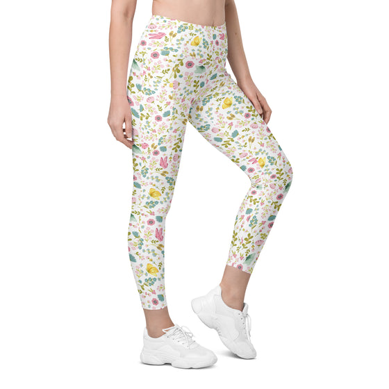 Model front view wearing white leggings with pastel floral print. High waist leggings with pockets, ideal for yoga, workouts, or casual spring style.