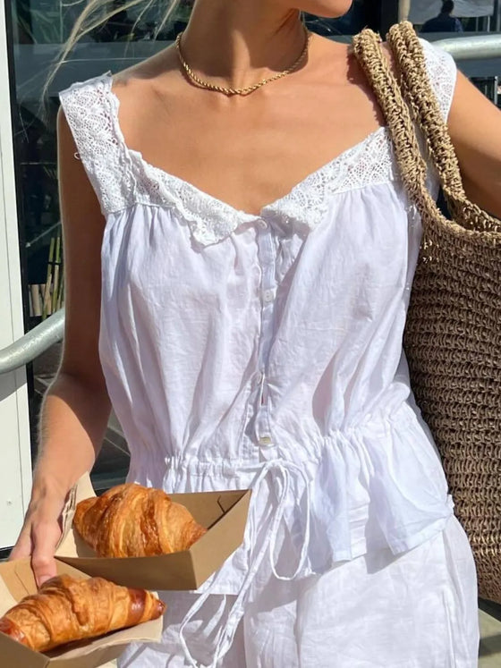  Front-facing image of the White Lace Detail Tank styled in a casual, breezy outfit.

