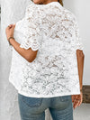 Back angle of white button-down lace shirt showing sheer fabric and elegant seam work.

