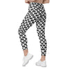 Woman modeling full view of lip pop white high waist leggings. Purple and black lips print adds flair to these compression leggings with side pockets.
