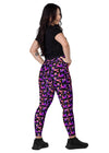 Back view of woman standing in Witchy Kitties Printed Black high-waist leggings with pockets. Soft fabric and unique print with pockets for added convenience.