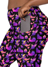 Plus-size woman showcasing the pockets on Witchy Kitties Printed Black high-waist leggings. Convenient and stylish, these leggings offer practicality and a playful design.