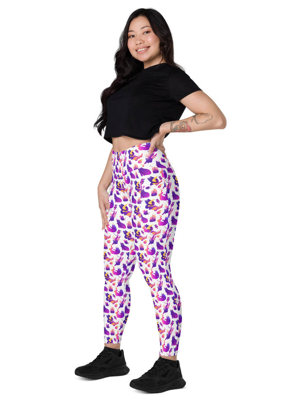 Side view of woman sitting in Witchy Kitties Printed White high-waist leggings with pockets. Chic and playful design with a flattering fit, perfect for lounging or workouts.