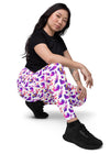 Full side view of woman wearing Witchy Kitties Printed White high-waist leggings with pockets. Fun, magical cat print with a flattering high-waist fit for comfort and style.