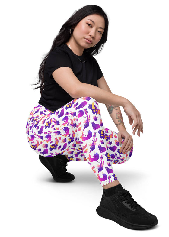 Full side view of woman wearing Witchy Kitties Printed White high-waist leggings with pockets. Fun, magical cat print with a flattering high-waist fit for comfort and style.