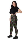 Model sitting sideways wearing neon roses black high-waisted leggings. Showcasing the vibrant floral print, high waist, and functional side pockets, perfect for an active and stylish lifestyle.