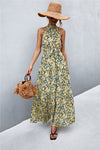 Full front view of yellow-green printed sleeveless maxi dress with tie waist—vibrant summer outfit perfect for beach days and daytime outings.