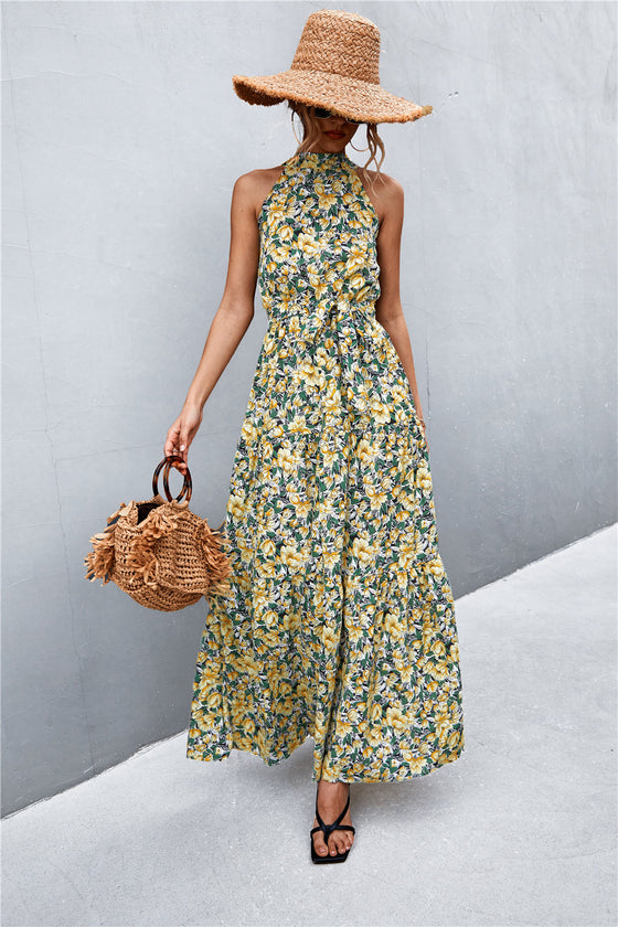 Full front view of yellow-green printed sleeveless maxi dress with tie waist—vibrant summer outfit perfect for beach days and daytime outings.