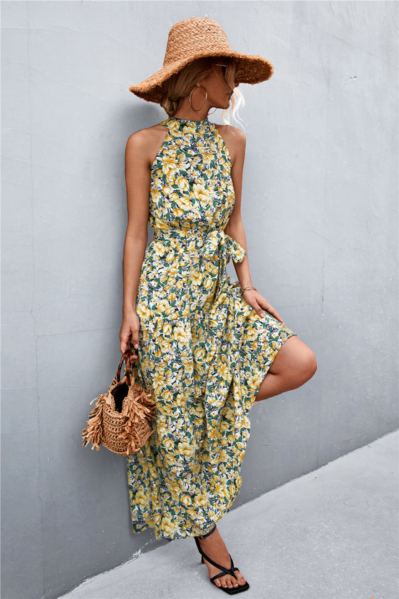 Stylish sleeveless maxi dress in yellow-green with a bold print and tie belt—breezy and flattering fit ideal for casual or resort wear.