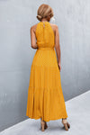 Back view of yellow sleeveless maxi dress with floral print—lightweight and flowy, ideal for sunny adventures or relaxed weekends.

