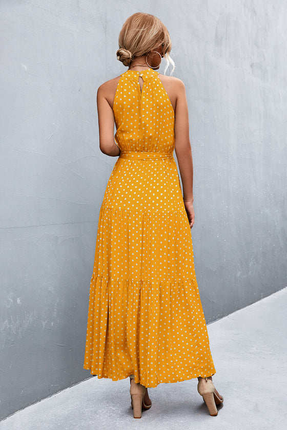 Back view of yellow sleeveless maxi dress with floral print—lightweight and flowy, ideal for sunny adventures or relaxed weekends.

