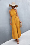 Sunshine yellow printed maxi dress with tie waist and sleeveless design—cheerful and feminine, perfect for beach days and holidays.