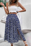 Model wearing the skirt in a vacation setting, highlighting the relaxed, breezy style.